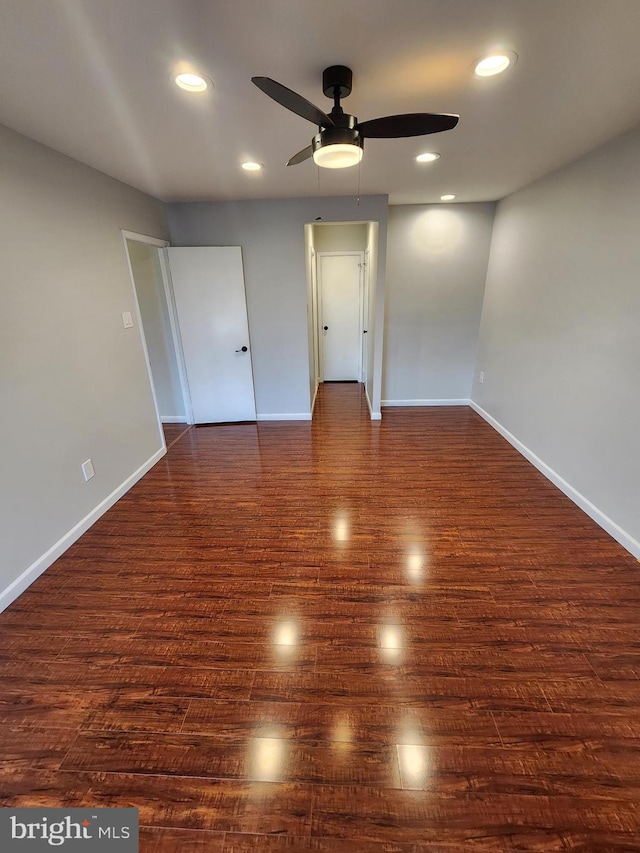 spare room featuring ceiling fan and dark hardwood / wood-style flooring