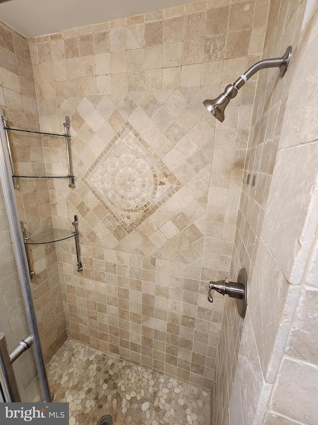 bathroom with tiled shower