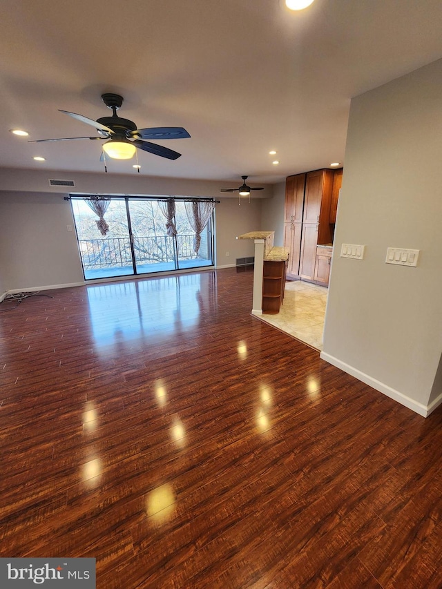 spare room with ceiling fan and dark hardwood / wood-style flooring