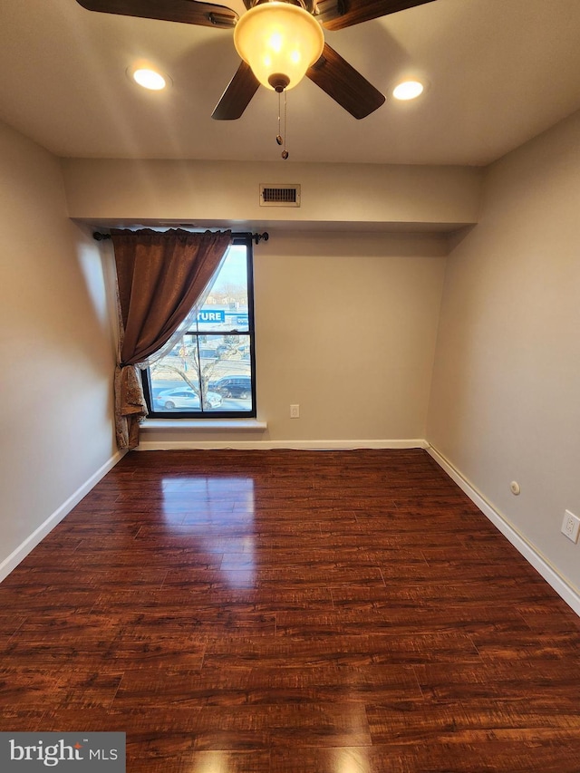 unfurnished room with dark hardwood / wood-style flooring and ceiling fan