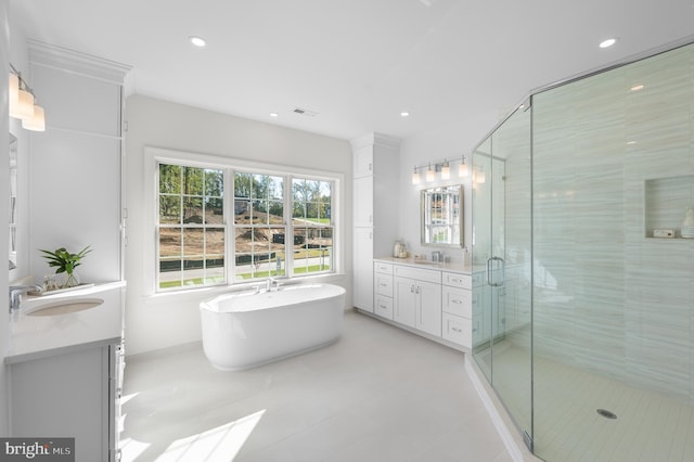 bathroom featuring vanity and independent shower and bath