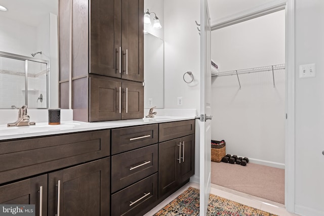 bathroom featuring vanity, tile patterned floors, and a shower with door