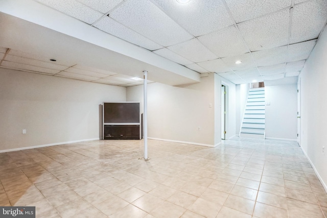 basement featuring a paneled ceiling