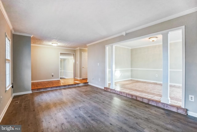 unfurnished room with decorative columns, crown molding, and dark hardwood / wood-style floors