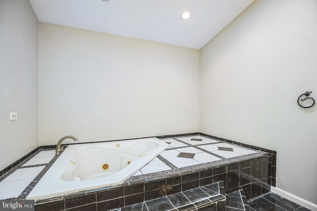 bathroom with tiled tub and tile patterned floors