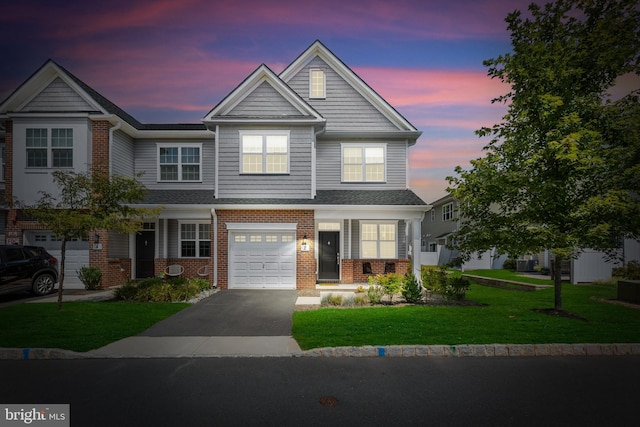 view of front of property with a yard and a garage