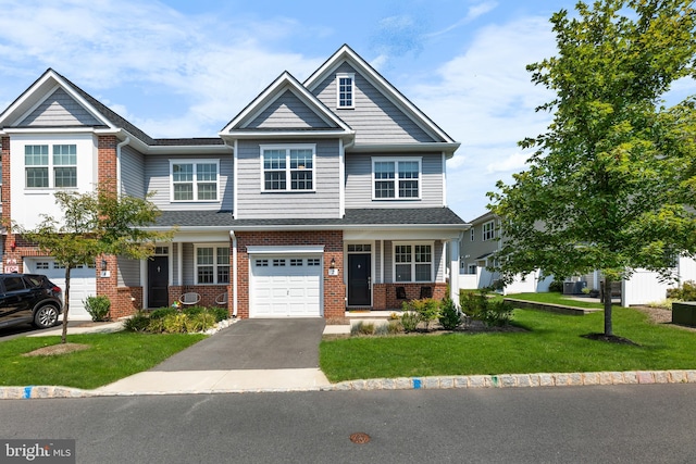 view of front of home with a front yard and a garage