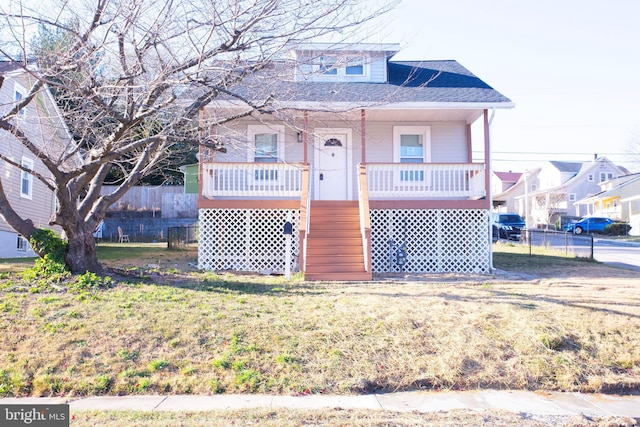 view of front of property with covered porch and a front lawn