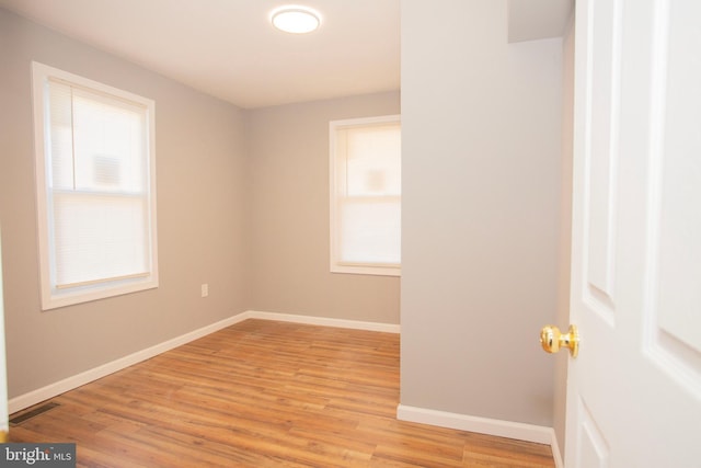 empty room featuring light hardwood / wood-style flooring and a wealth of natural light