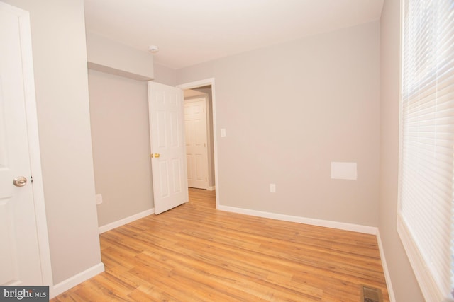 spare room with light hardwood / wood-style flooring