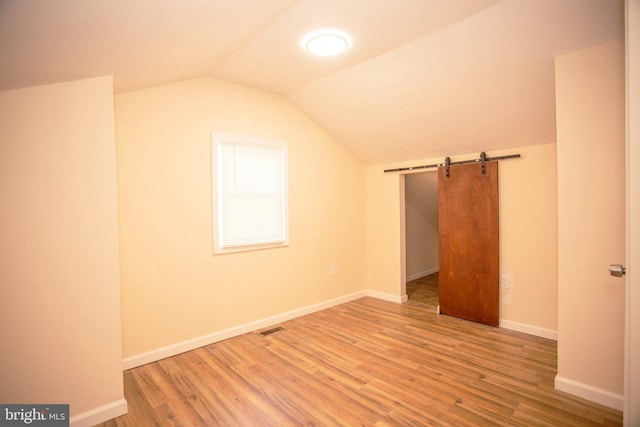 bonus room featuring hardwood / wood-style floors and vaulted ceiling