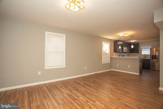 unfurnished living room with dark hardwood / wood-style flooring and sink