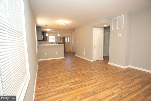 unfurnished living room featuring hardwood / wood-style flooring