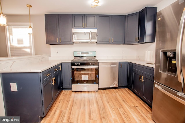 kitchen with pendant lighting, light stone countertops, light wood-type flooring, appliances with stainless steel finishes, and kitchen peninsula