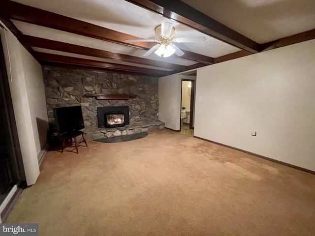 basement featuring a stone fireplace, light carpet, and ceiling fan