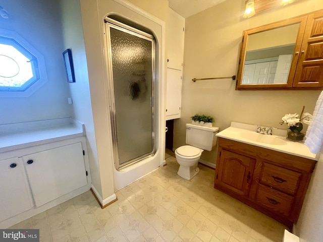 bathroom with vanity, an enclosed shower, and toilet