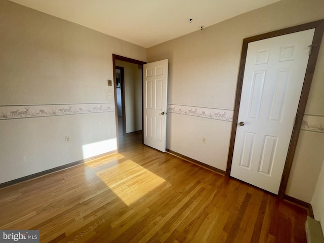 unfurnished bedroom featuring hardwood / wood-style flooring