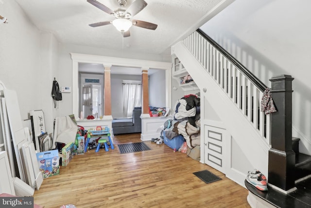 interior space with hardwood / wood-style floors, ceiling fan, and a textured ceiling