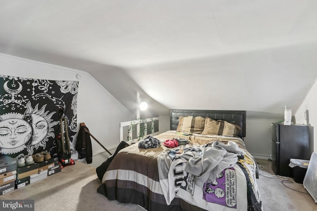 carpeted bedroom with lofted ceiling