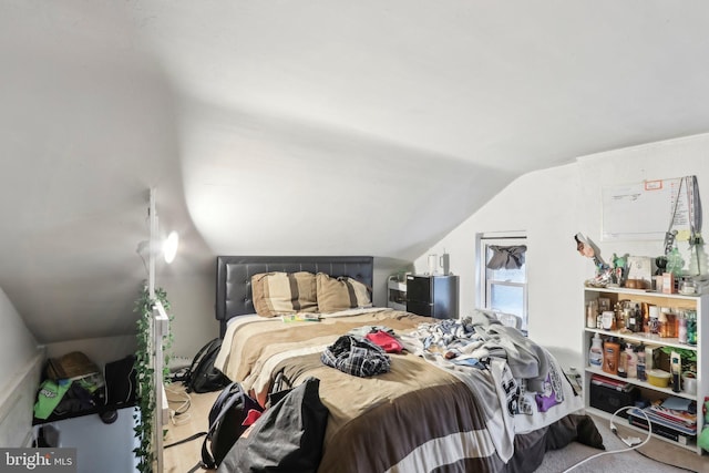 carpeted bedroom with vaulted ceiling