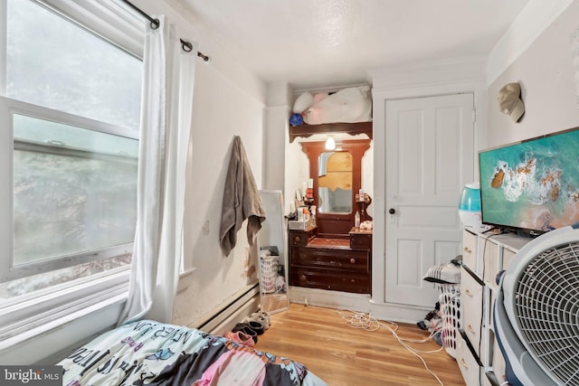 interior space with a baseboard radiator and light hardwood / wood-style flooring