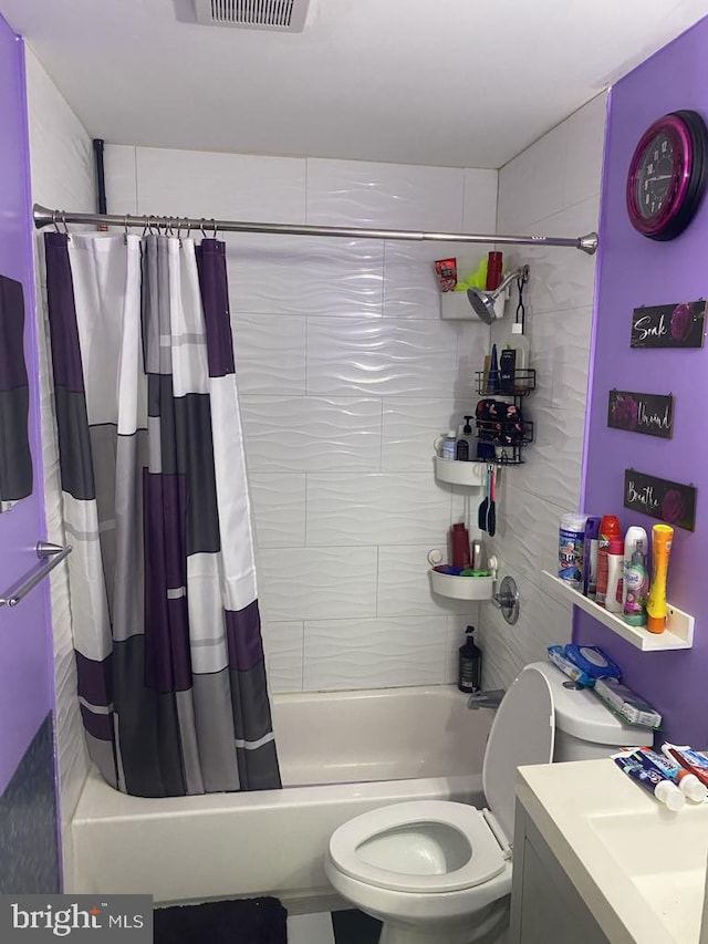 full bathroom featuring vanity, shower / bath combo, and toilet