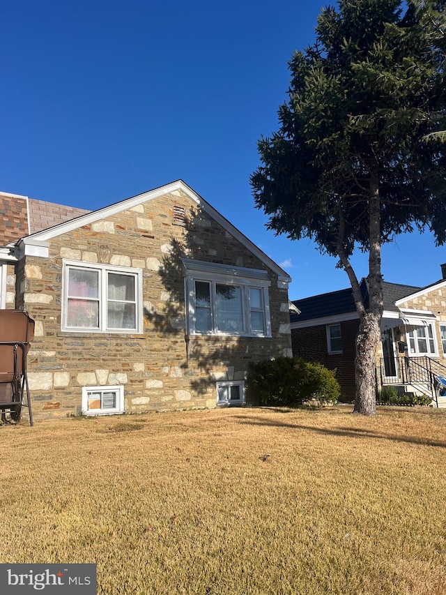 back of house with a lawn