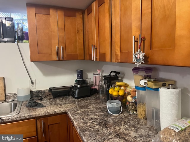 kitchen featuring sink and dark stone counters