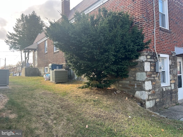 view of property exterior featuring a yard and cooling unit