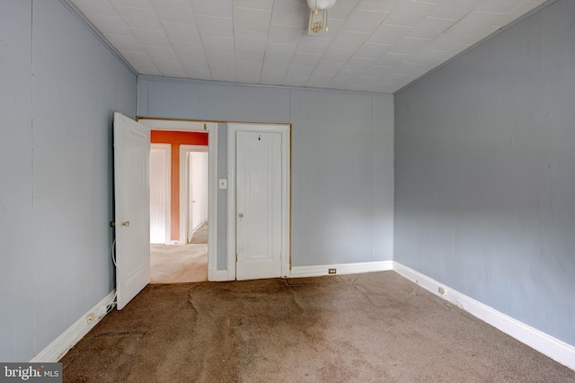 spare room with carpet flooring and crown molding