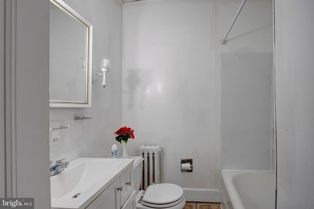 bathroom with vanity, toilet, and radiator