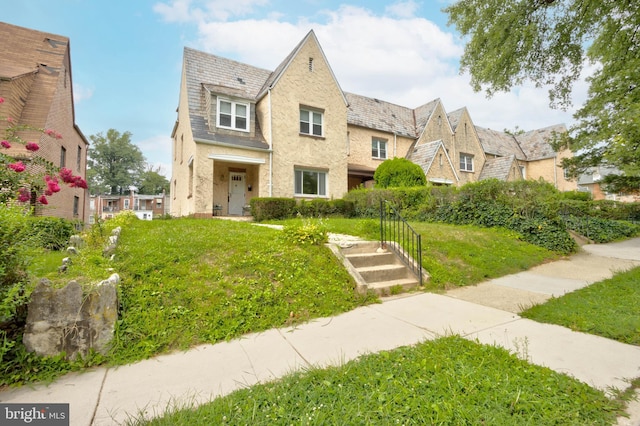 tudor home with a front yard