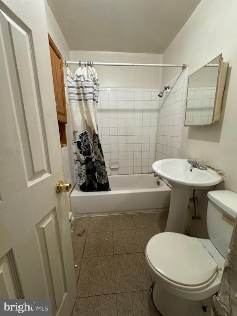 bathroom with shower / bath combo and toilet