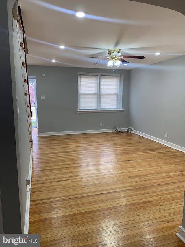 unfurnished room featuring ceiling fan and light wood-type flooring