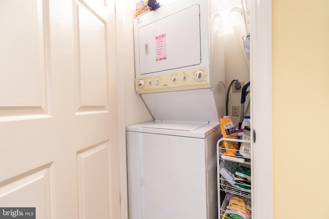 laundry room with stacked washing maching and dryer