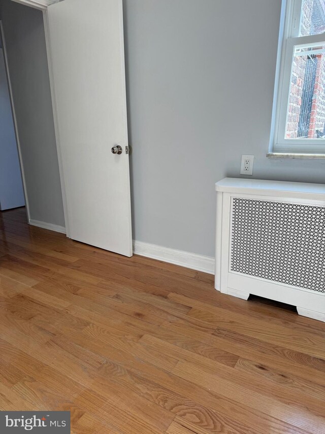 interior space with light wood-type flooring and radiator