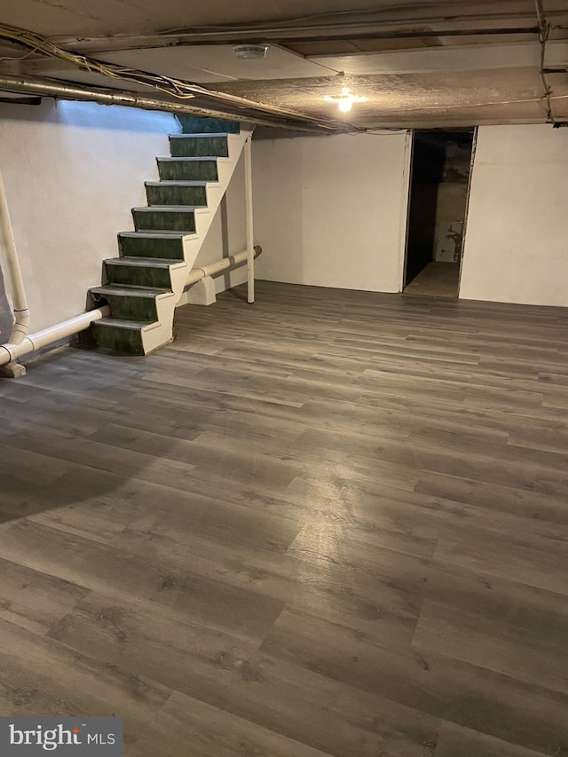 basement featuring dark hardwood / wood-style floors