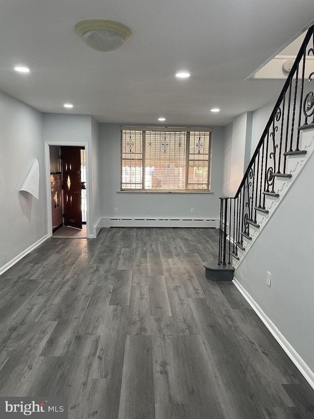 foyer featuring a baseboard heating unit and dark hardwood / wood-style flooring