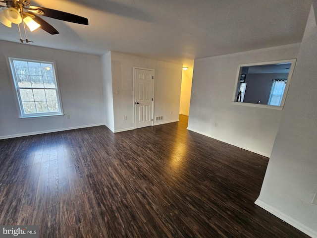 empty room with dark hardwood / wood-style floors and ceiling fan