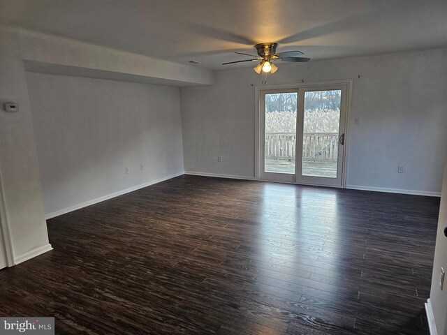 empty room featuring dark hardwood / wood-style flooring and ceiling fan