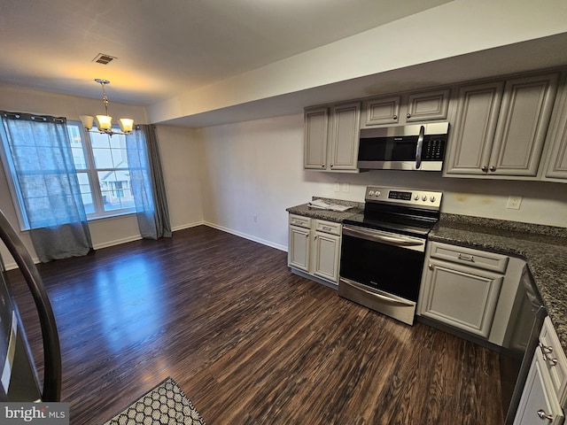 kitchen featuring gray cabinetry, hanging light fixtures, stainless steel appliances, dark hardwood / wood-style floors, and a notable chandelier