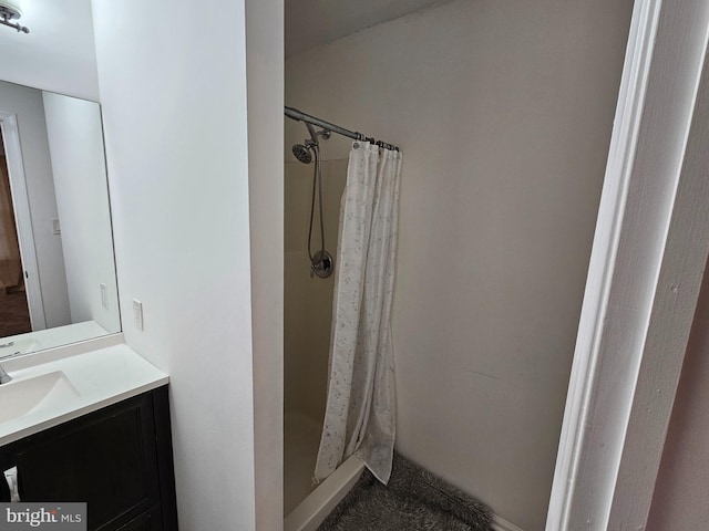 bathroom with a shower with curtain and vanity