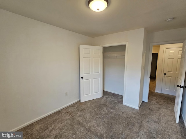 unfurnished bedroom with carpet floors and a closet