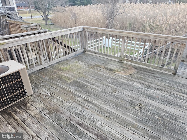 wooden deck featuring central AC unit