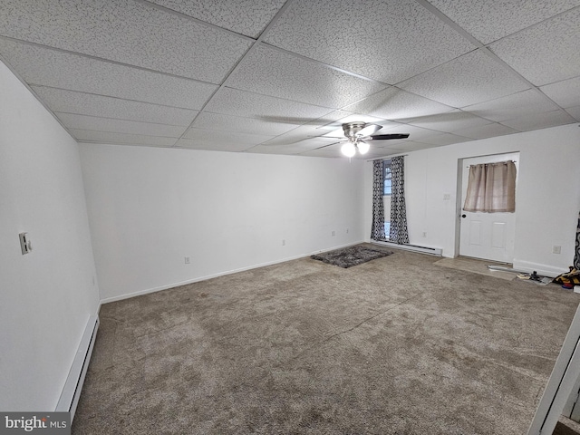 carpeted empty room with ceiling fan and a drop ceiling