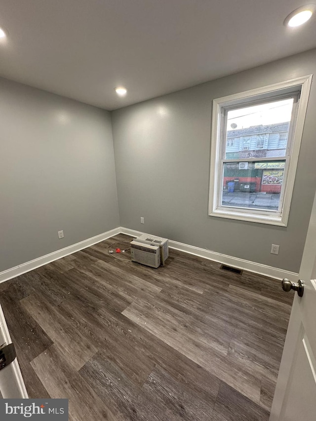 spare room with dark wood-type flooring