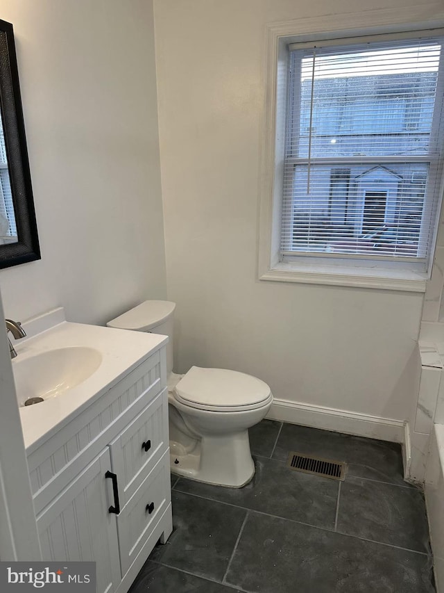 bathroom featuring tile patterned flooring, vanity, and toilet