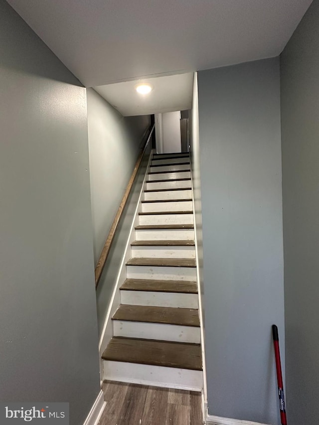 stairs featuring wood-type flooring