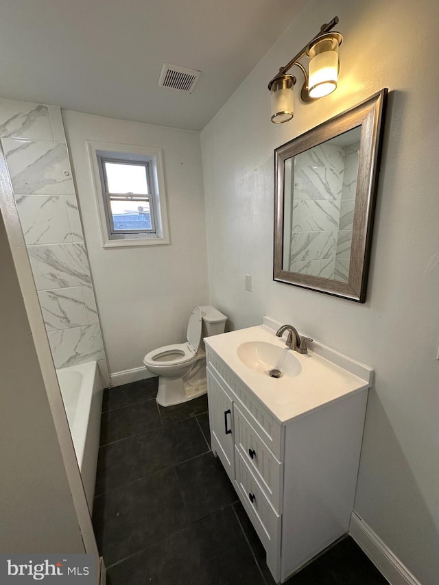 bathroom featuring tile patterned flooring, vanity, and toilet