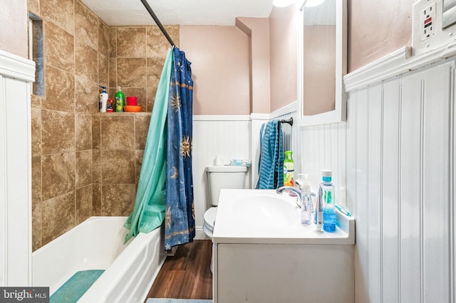 full bathroom with shower / tub combo, vanity, a textured ceiling, hardwood / wood-style flooring, and toilet